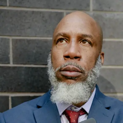Harold Grant, holding the only printed copy of the terms.